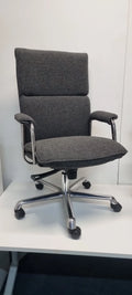 Gray office chair with a high backrest on a white surface.