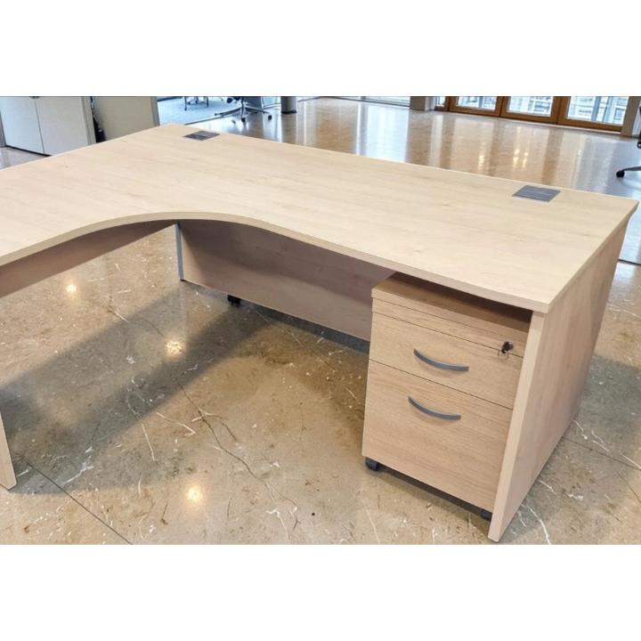 Beige L-shaped office desk with drawers in a modern office setting