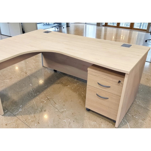 Beige L-shaped office desk with drawers in a modern office setting